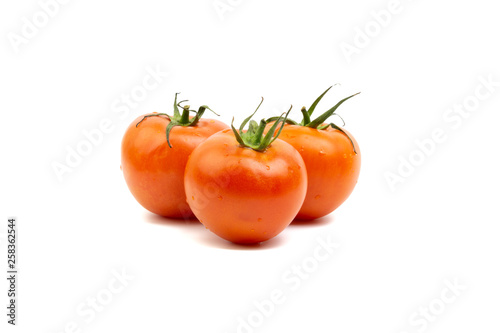 Tomato closeup on white background. Selective focus and crop fragment