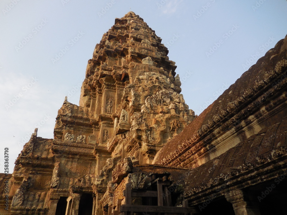 The top of the ancient stone temple covered with the ruin of graceful reliefs