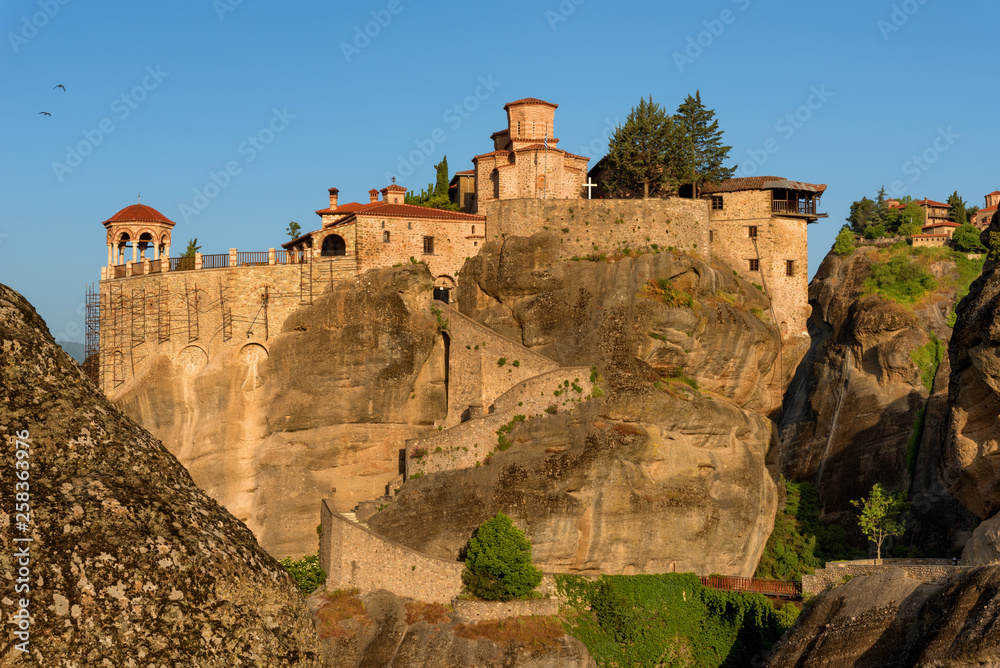 Great Meteoron Monastery. Beautiful scenic view, ancient traditional greek building on the top of huge stone pillar in Meteora, Eastern Orthodox Church, Pindos, Thessaly, Greece, Europe. Great Meteoron Monastery. Beautiful scenic view, ancient traditional greek building on the top of huge stone pillar in Meteora, Eastern Orthodox Church, Pindos, Thessaly, Greece, Europe.