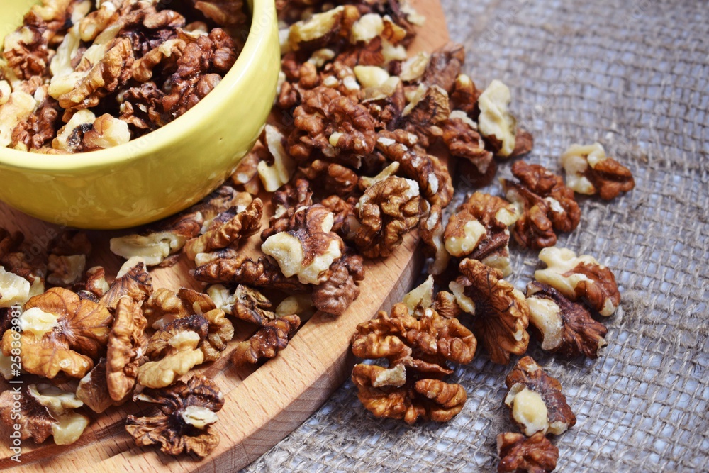 Useful walnuts on a burlap and wood background. Useful walnuts on a burlap and wood background.