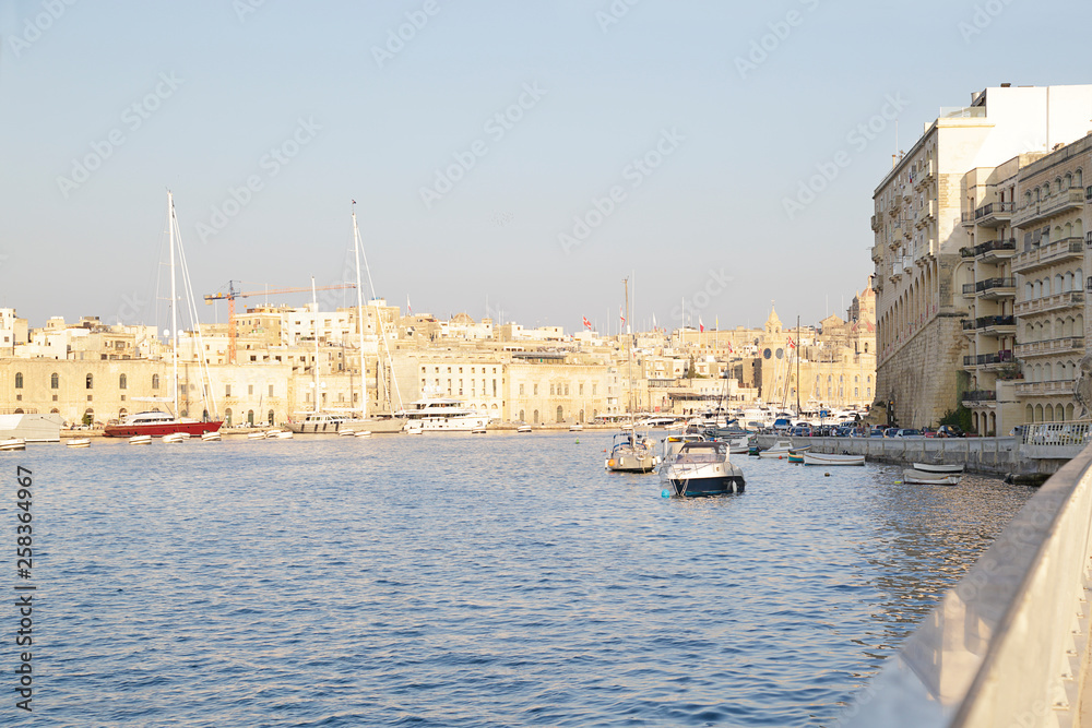 Medieval edifices and churches of Birgu (Vittoriosa) with moored yachts and boats, Malta