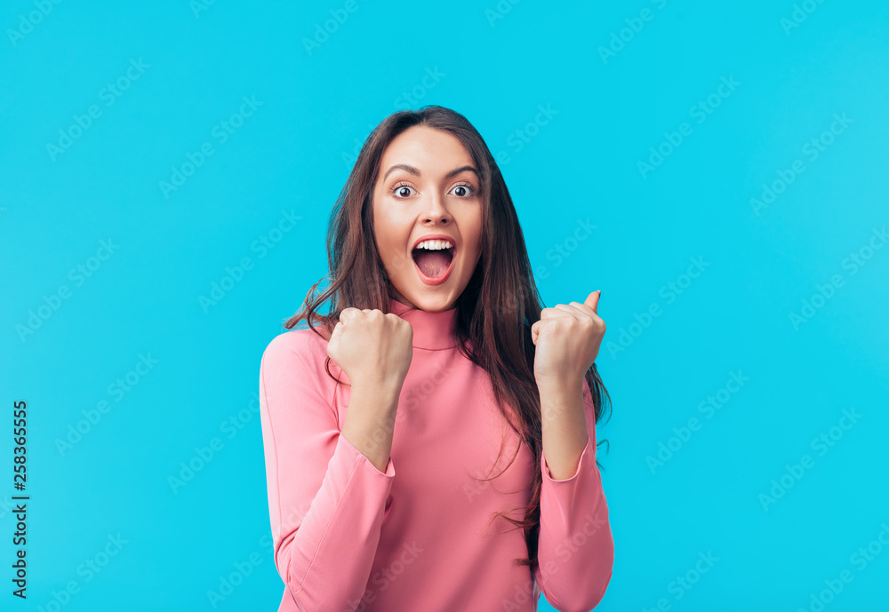 Happy excited woman celebrate success isolated on blue background - obrazy, fototapety, plakaty 