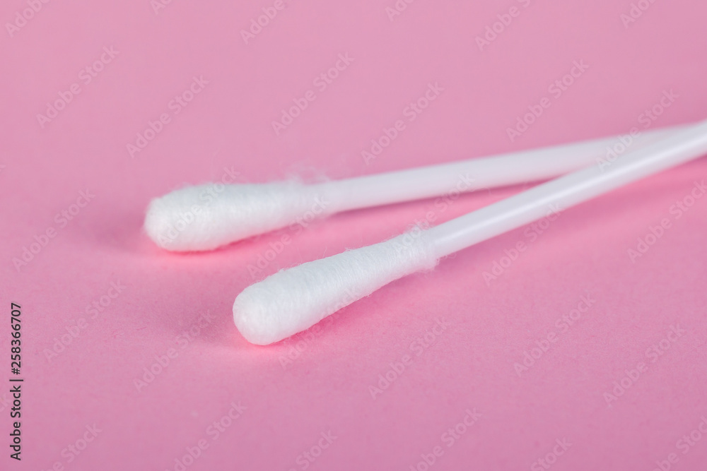 sticks for cleaning ears on a pink background sticks for cleaning ears on a pink background