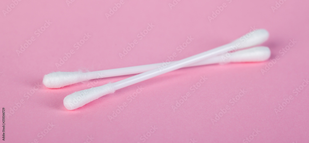 sticks for cleaning ears on a pink background sticks for cleaning ears on a pink background