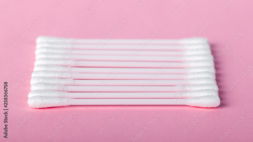 sticks for cleaning ears on a pink background sticks for cleaning ears on a pink background