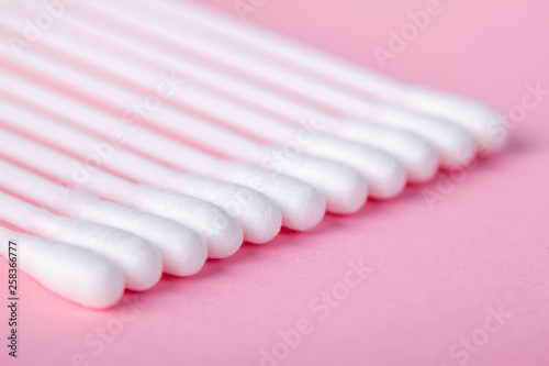 sticks for cleaning ears on a pink background