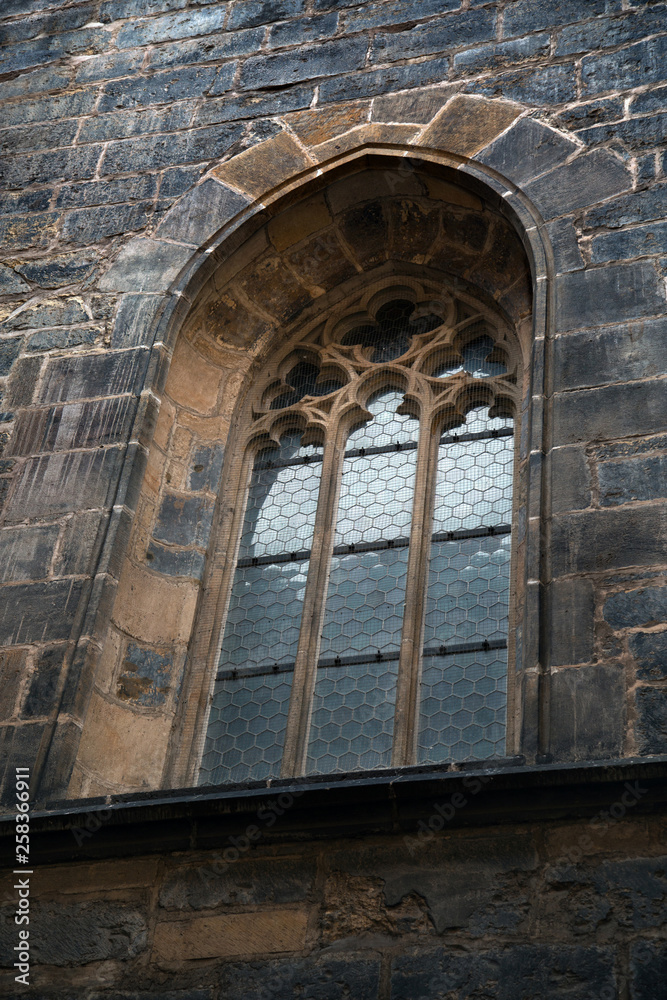 Arched window with grate of Prague temple