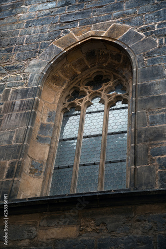 Arched window with grate of Prague temple