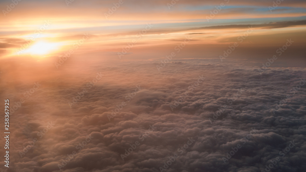 Aerial traveling. Flying at dusk or dawn. Fly through orange cloud and sun. Aerial traveling. Flying at dusk or dawn. Fly through orange cloud and sun.