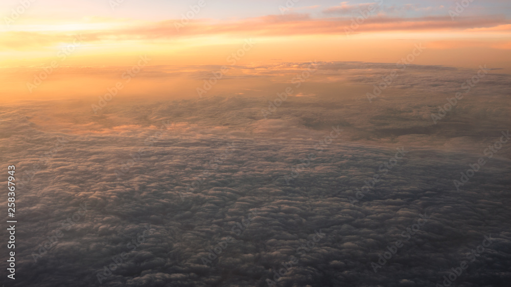Aerial traveling. Flying at dusk or dawn. Fly through orange cloud and sun. Aerial traveling. Flying at dusk or dawn. Fly through orange cloud and sun.