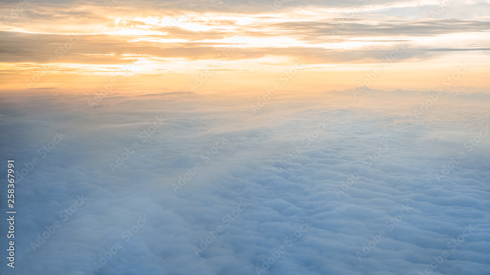 Aerial traveling. Flying at dusk or dawn. Fly through orange cloud and sun.