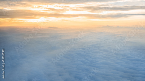 Aerial traveling. Flying at dusk or dawn. Fly through orange cloud and sun.