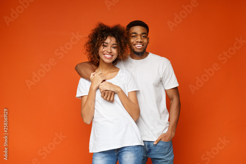 Adorable african-american couple in love smiling at camera
