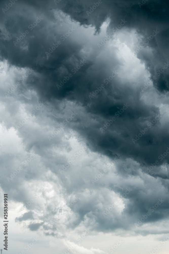 storm cloud background during raining. Dark Clouds. Huge black clouds on dark sky before a thunder-storm.