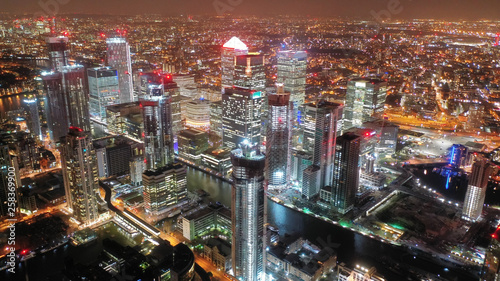 Aerial drone night shot from iconic Canary Wharf skyscrapers business area, Isle of Dogs, London, United Kingdom, 