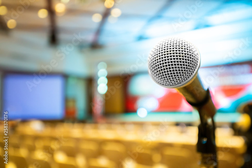 Microphone stand abstract blurred photo in conference hall or seminar room background, no people,