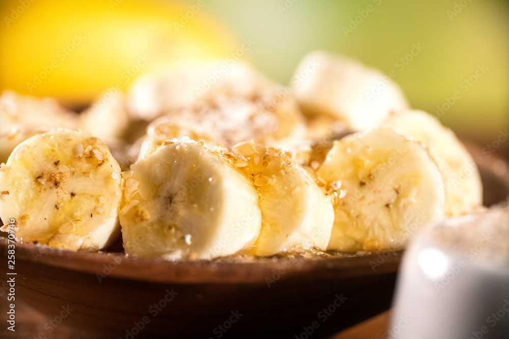 oatmeal with banana and honey in bowl, close-up, horizontal