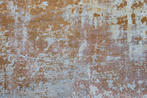 Macro texture of peeled paint on a white concrete wall.