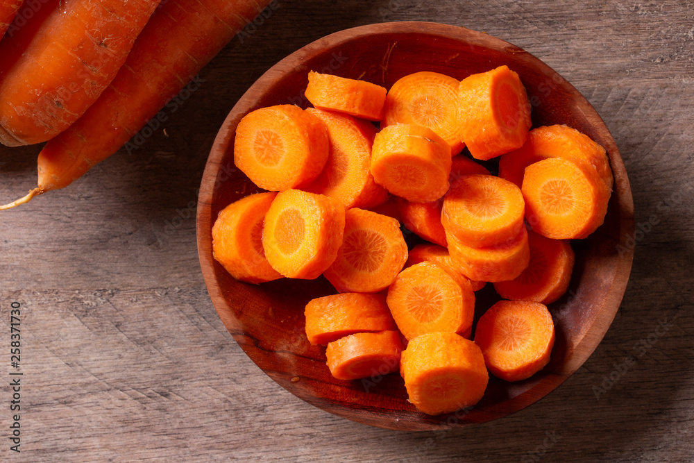 Carrots and carrot sliced on wooden table. Selective focus. Carrots and carrot sliced on wooden table. Selective focus.