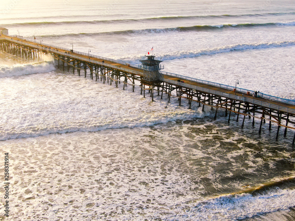 Aerial view of San Clemente Pier with lifeguard tower for surfer. San Clemente city in Orange County, California, USA. Travel destination in the South West Coast. Famous beach for surfer. 01/25/2018