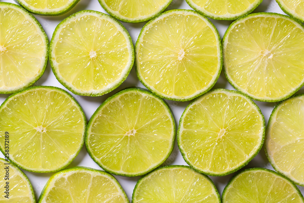 A slices of fresh juicy green lemons. Texture background, pattern A slices of fresh juicy green lemons. Texture background, pattern