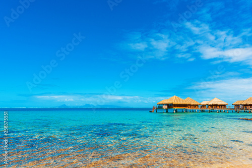 View of the Water Bungalow in the lagoon Huahine, French Polynesia with clear turquoise calm Ocean . Copy space for text. © ggfoto