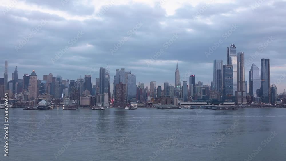 (Time-Lapse) Clouds move across the midtown Manhattan, New York City skyline, with boats traveling on the Hudson River. (Time-Lapse) Clouds move across the midtown Manhattan, New York City skyline, with boats traveling on the Hudson River.
