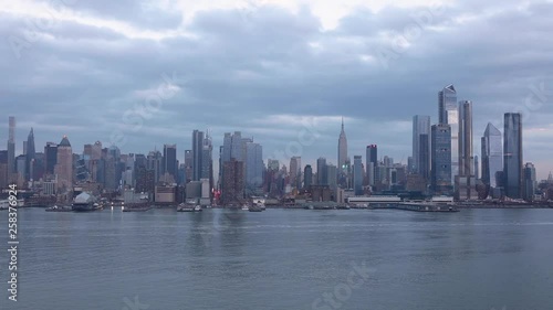 Wallpaper Mural (Time-Lapse) Clouds move across the midtown Manhattan, New York City skyline, with boats traveling on the Hudson River. Torontodigital.ca