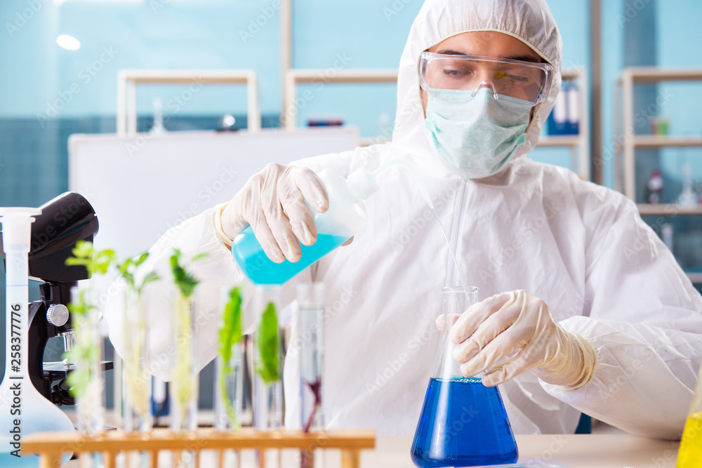 Male biotechnology scientist chemist working in the lab Male biotechnology scientist chemist working in the lab