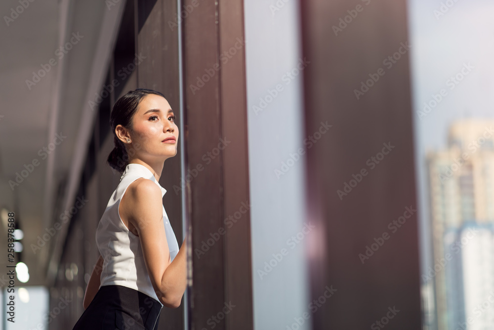 Businesswoman working in the office with looking out of the window