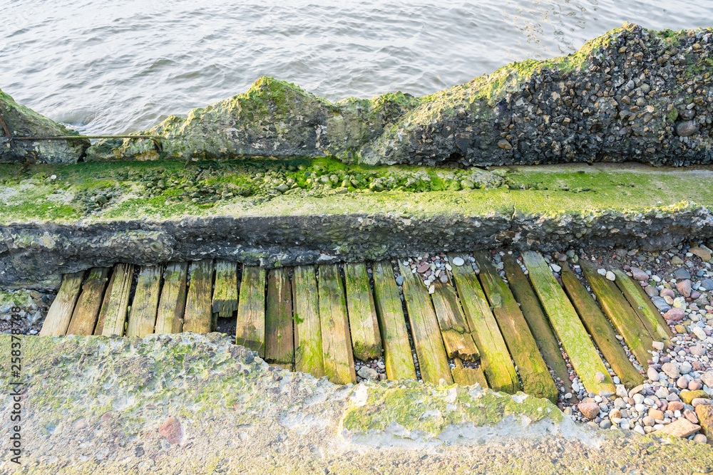 Fototapeta premium Destroyed coastal concrete protective structure.