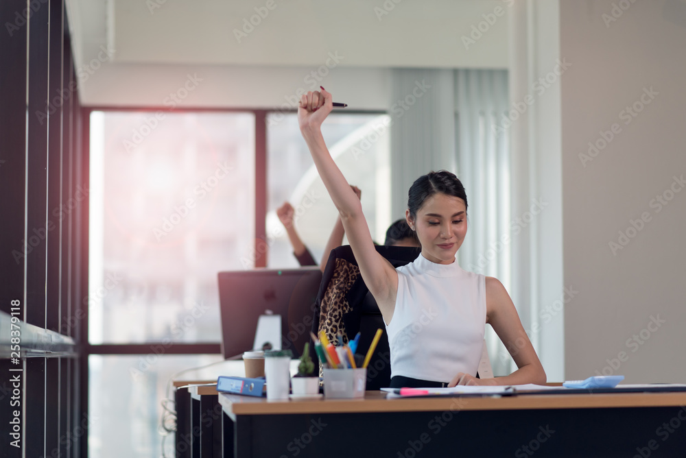 Obraz premium Happy business woman working in the office with your hands up