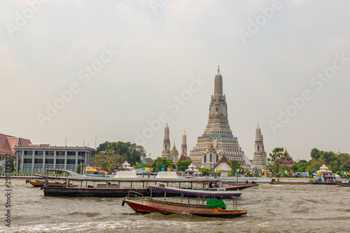 Wat Arun agianst beautiful scene of Chao Phraya river in the morning, Bangkok, Thailand