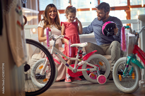 happy family with child buying new bicycle.