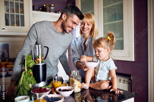 Family with daughter eating in kitchen