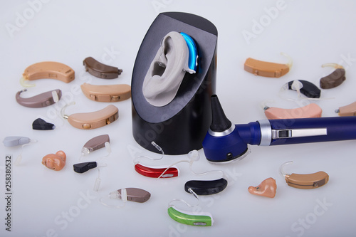 Various hearing aids on white background, alternative to surgery. ENT accessory