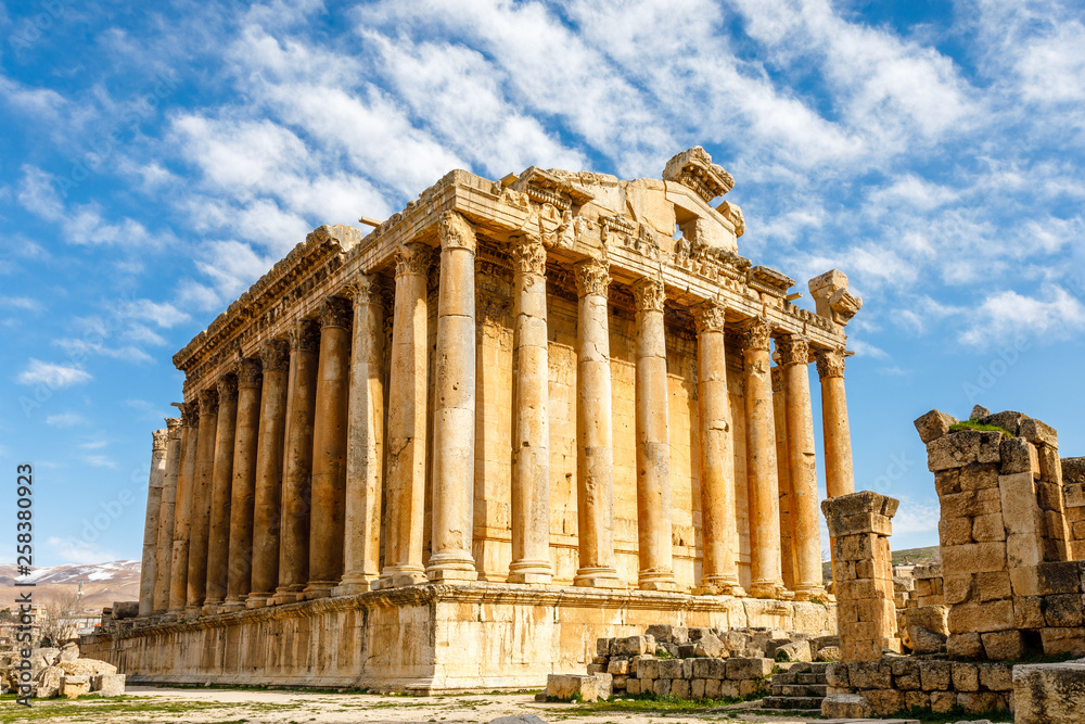 Ancient Roman temple of Bacchus with surrounding ruins with blue sky in the background, Bekaa Valley, Baalbek, Lebanon