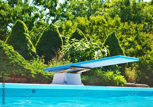 Water level view of a diving board on a bright and sunny day