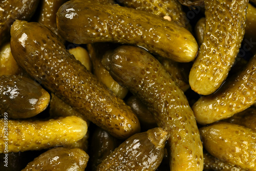 Top view, extreme close up of pickled gherkins (small cucumbers). Macro food texture background with pickles photo