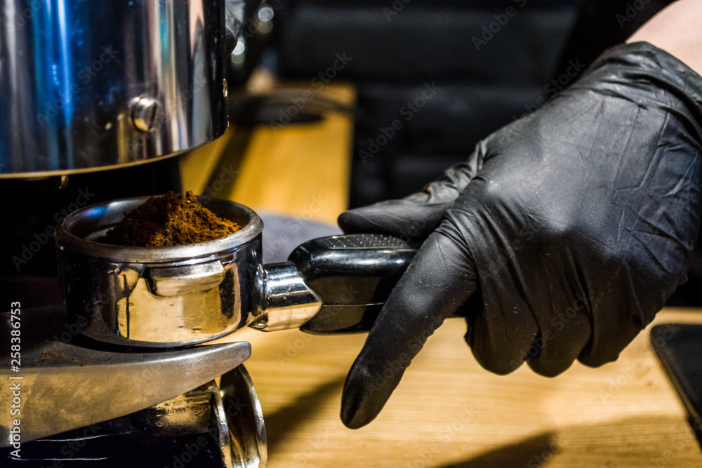Process of preparation of espresso the coffee machine in cafe. A beans grinding in the holder. Work barista. Fresh drink Process of preparation of espresso the coffee machine in cafe. A beans grinding in the holder. Work barista. Fresh drink
