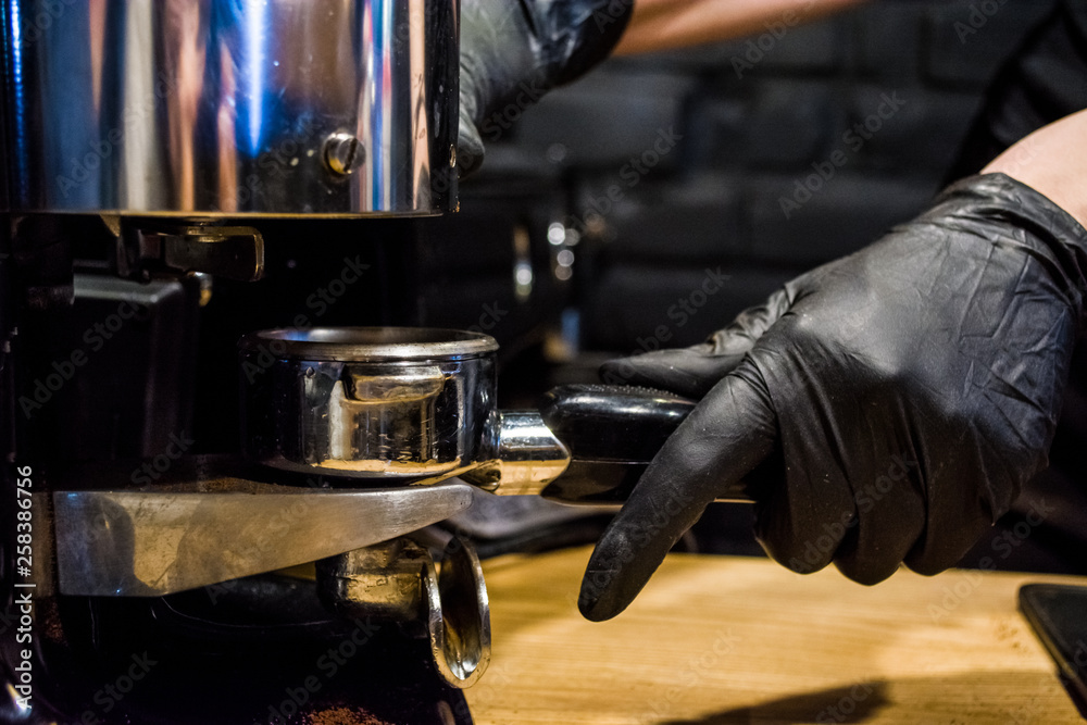 Process of preparation of espresso the coffee machine in cafe. A beans grinding in the holder. Work barista. Fresh drink Process of preparation of espresso the coffee machine in cafe. A beans grinding in the holder. Work barista. Fresh drink