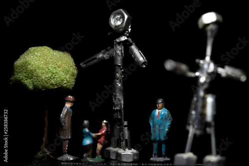 Tablou pe pânză Scene of miniature scale model elements with a tree, playing children and statue