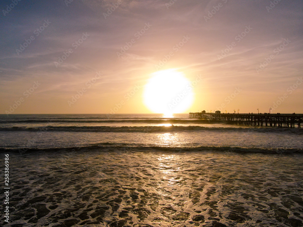 Aerial view of San Clemente Pier during beautiful sunset time. San Clemente city in Orange County, California, USA. Travel destination in the South West coast. Sunset color reflection over the water.