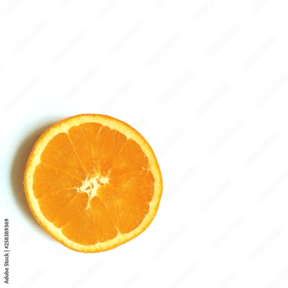 flatlay layout slice of orange in the center of white background flatlay layout slice of orange in the center of white background
