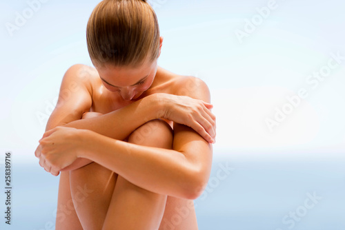 Young woman sitting photo
