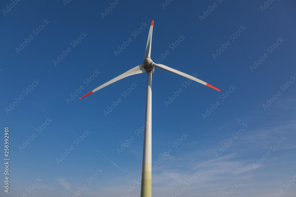 wind turbine with sun flare blue sky background view from below wind turbine with sun flare blue sky background view from below