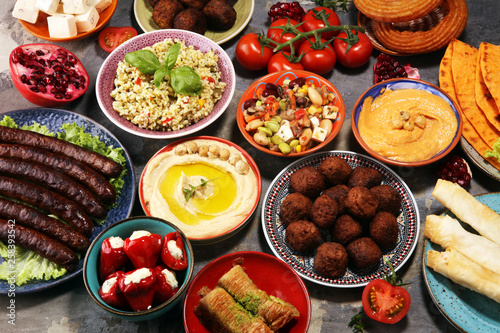 Middle eastern or arabic dishes and assorted meze, concrete rustic background. Falafel. Turkish Dessert Baklava with pistachio. Halal food. Lebanese cuisine
