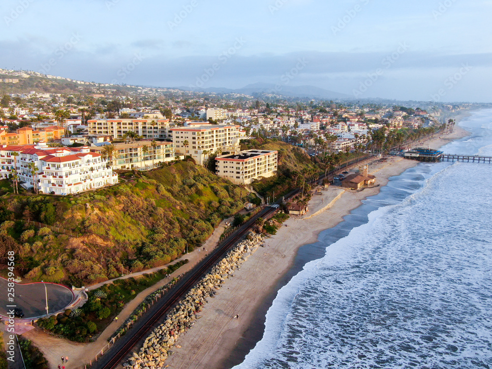 Aerial view of San Clemente Pier with beach and coastline before sunset time . San Clemente city in Orange County, California, USA. Travel destination in the South West Coast. Famous beach for surfer.
