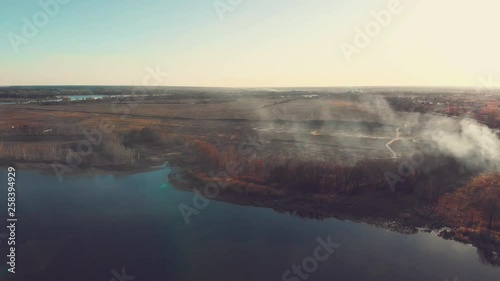 Aerial view of a river side burning in spring