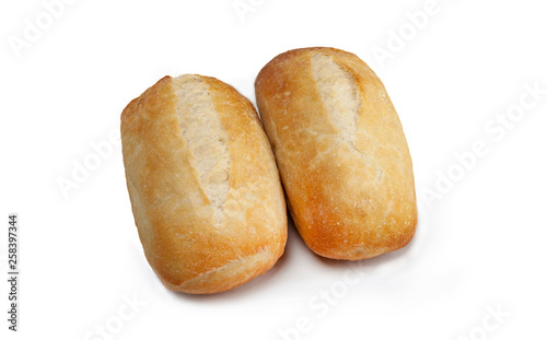 two buns with a golden crust on a white background close-up